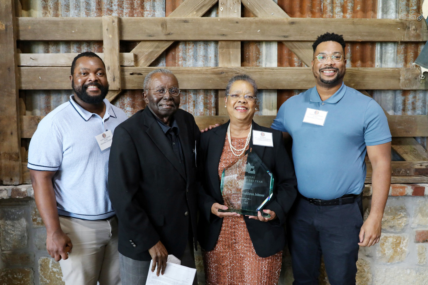 Dr. Beverly Waddleton Johnson of Quitman was presented the regional citizen of the year award last week by the East Texas Council of Governments. Attending the event were her husband, Dr. John Johnson, and sons Alston, left, and Travers.